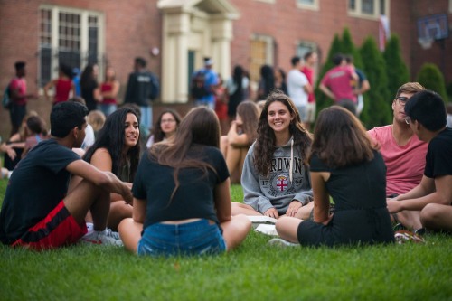 Brown University students gathered and sitting on a lawn